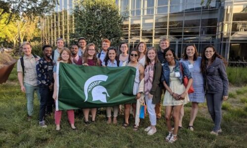 group of students with spartan flag